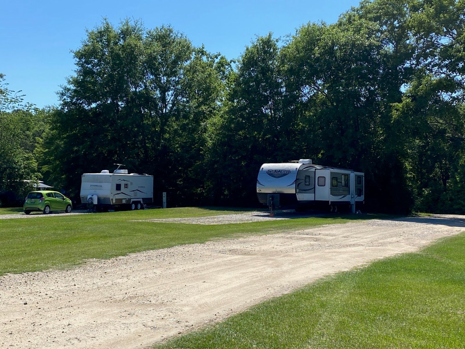 A spacious shaded RV lot at Ivy Hill Campground